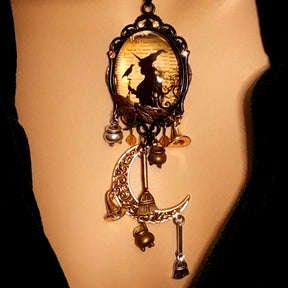 Double-sided handmade witchy necklace featuring a witch, raven, crescent moon, filigree details, dangling charms, and Swarovski crystals, Victorian style and vintage style magical fantasy jewelry by Rachel Flam Design