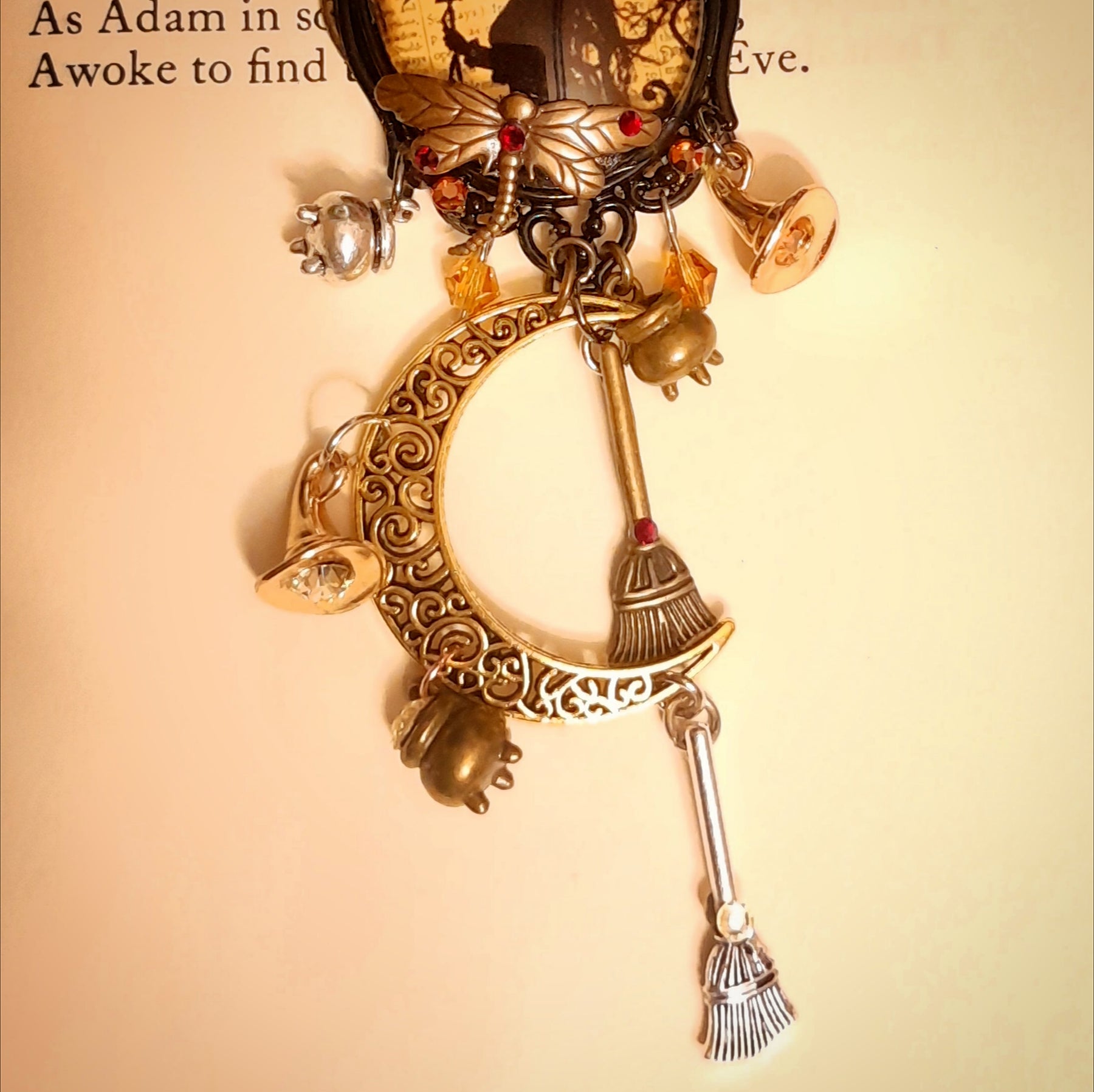 One of a kind witchy moon necklace filled with a raven, crescent moon, tiny witch charms, broomsticks, potions, and Swarovski crystals, Victorian style and vintage style fantasy jewelry by Rachel Flam Design