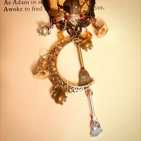 One of a kind witchy moon necklace filled with a raven, crescent moon, tiny witch charms, broomsticks, potions, and Swarovski crystals, Victorian style and vintage style fantasy jewelry by Rachel Flam Design