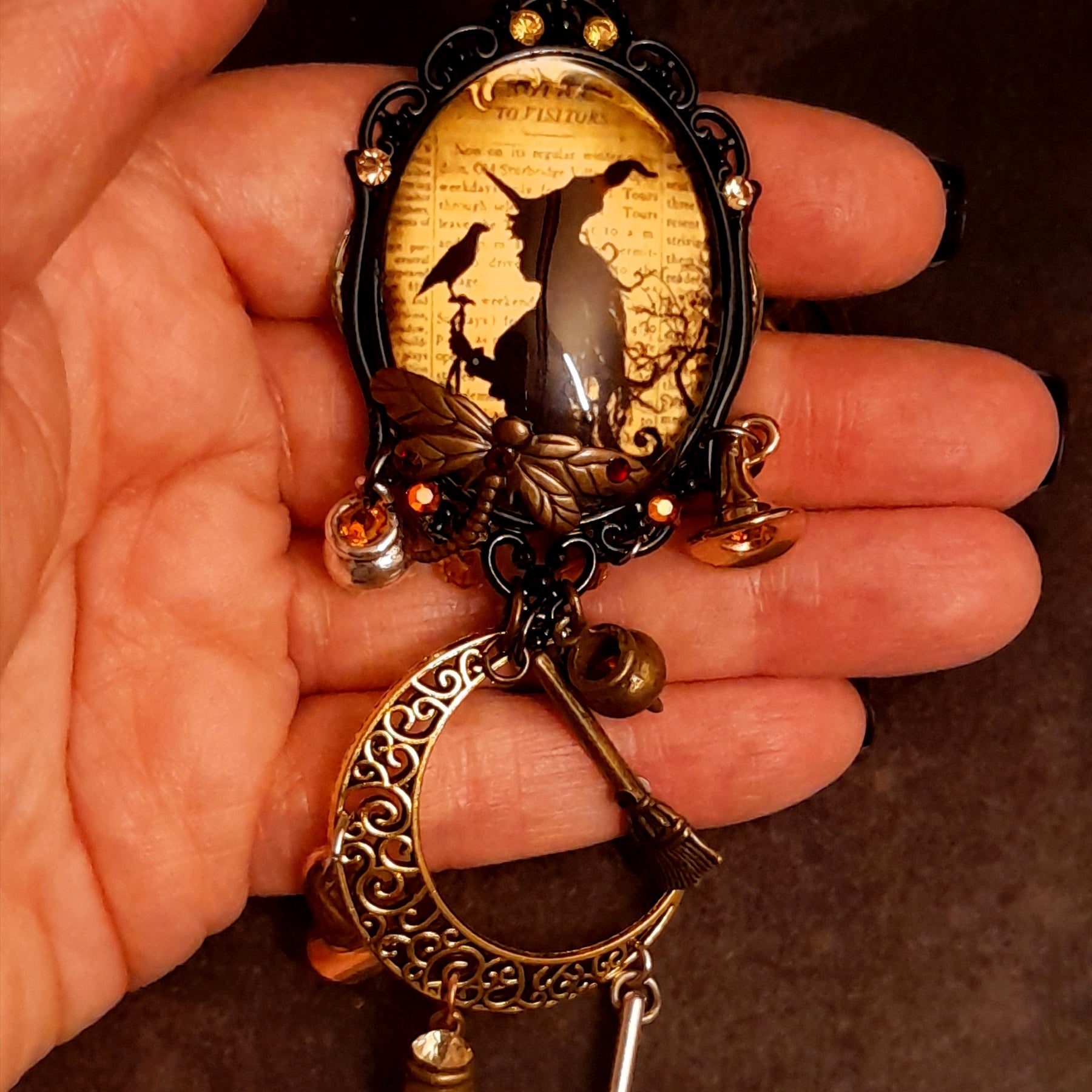 Elaborate handmade witchy necklace with crescent moon, raven, witch hat, broomsticks, potion vessels, and Swarovski crystals, Victorian style and vintage style fantasy jewelry by Rachel Flam Design
