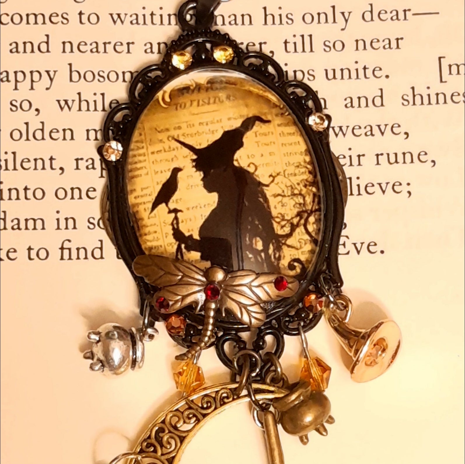 Handmade necklace with an ornate witch portrait, raven, crescent moon, crystal drops, broomsticks, and potion charms, Victorian style and vintage style magical fantasy jewelry by Rachel Flam Design