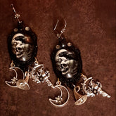 Handmade witchy raven and skull earrings with pale moon imagery, smoky Swarovski crystals, crescent moon charms, witch figures, and celestial details, Victorian style and vintage style magical fantasy jewelry by Rachel Flam Design