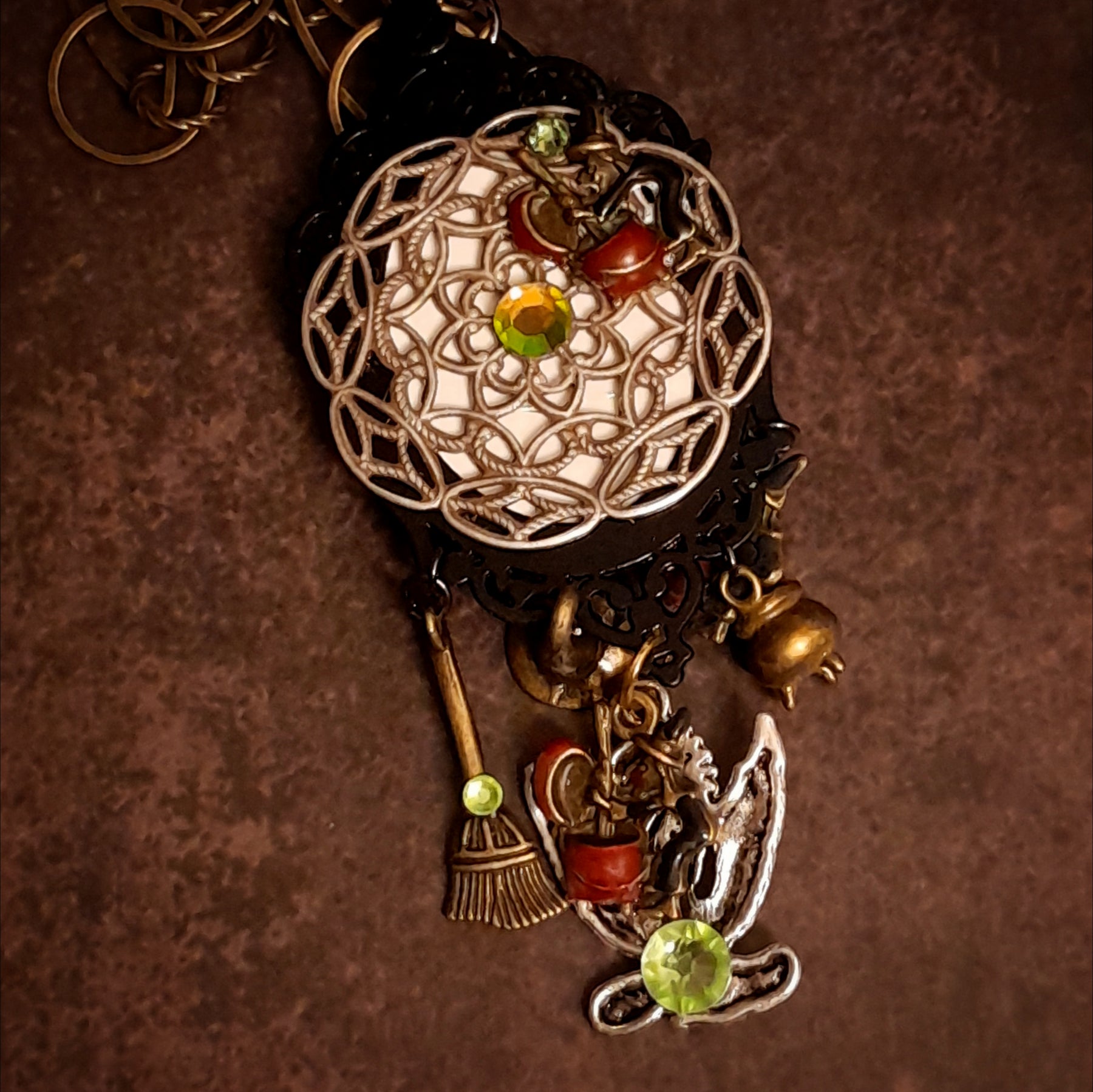 Victorian style vintage style fantasy jewelry necklace with mysterious castle pendant, dragon detail, broom charm, and Swarovski crystals, Rachel Flam Design


