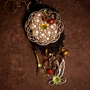 Victorian style vintage style fantasy jewelry necklace with mysterious castle pendant, dragon detail, broom charm, and Swarovski crystals, Rachel Flam Design

