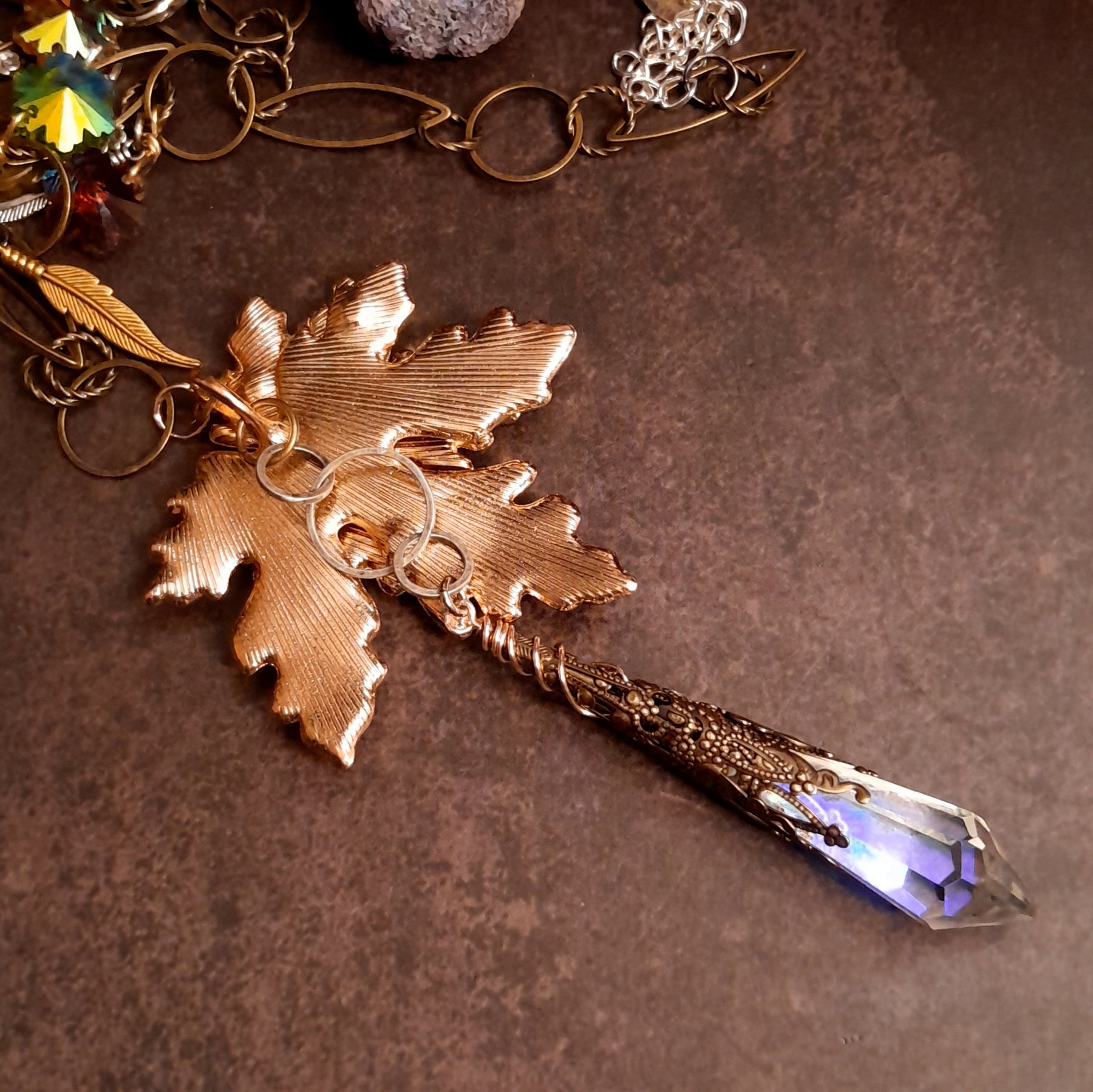 Close view of a magical Halloween woodland necklace with pumpkin charms, leaves and sparkling Swarovski crystals in Victorian style and vintage style by Rachel Flam Design