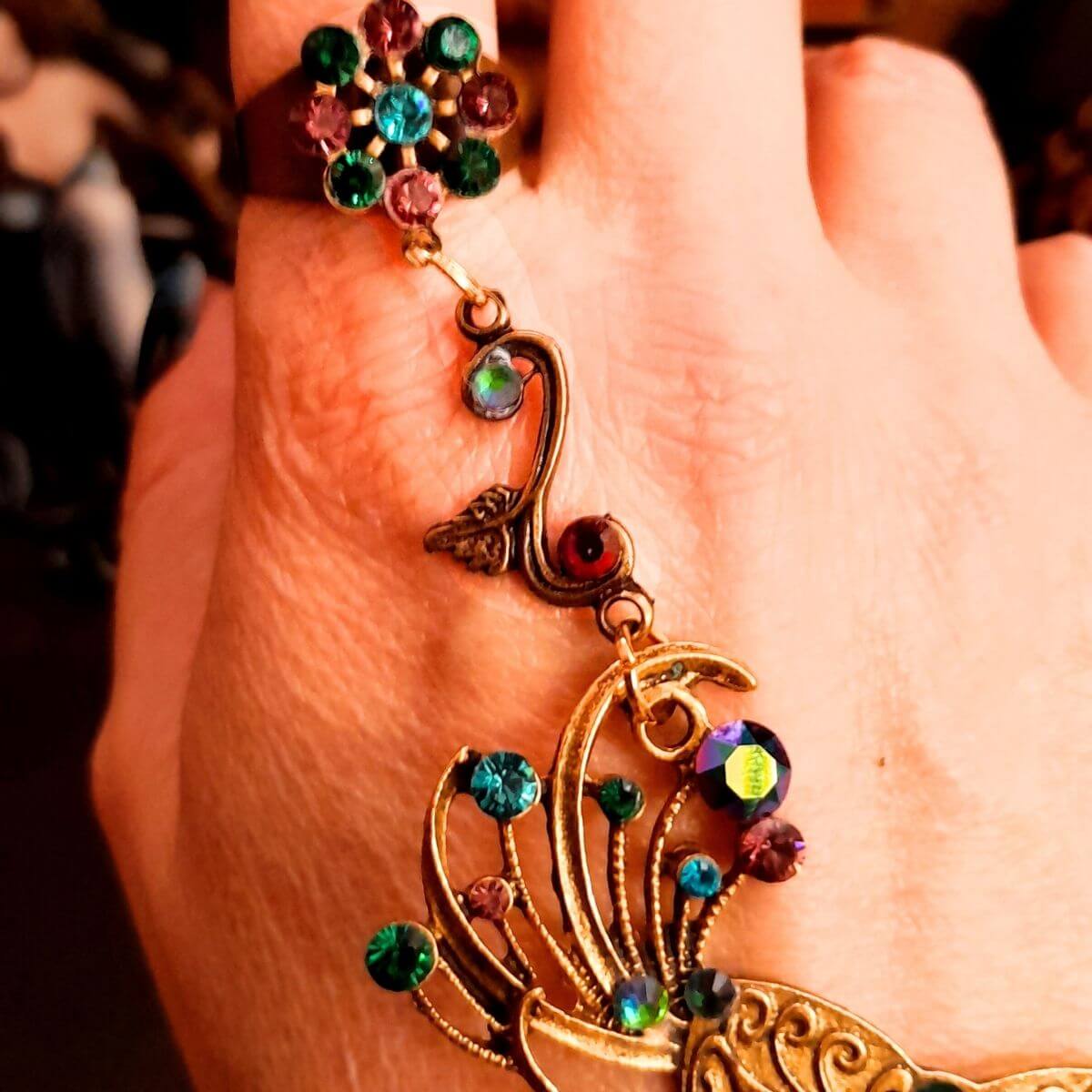 slave bracelet hand chain with adjustable flower ring and masks. colcorful flowers and vines a serpent snake and swarovski crystals