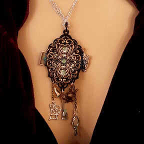 fairytale necklace with book mirror spinning wheel crest magic lamp witch hat broom and crow on books