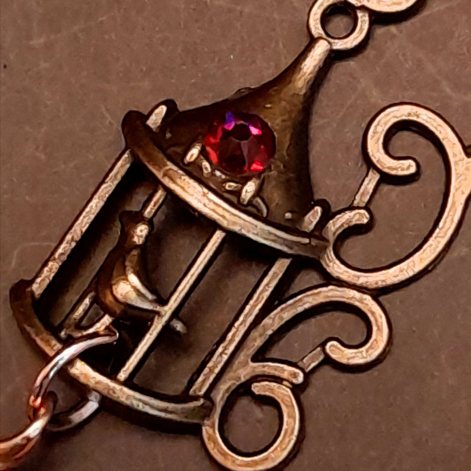 gold moon and star bird cage earrings with blue and purple color changing drop crystals 