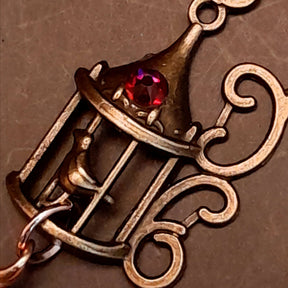 gold moon and star bird cage earrings with blue and purple color changing drop crystals 