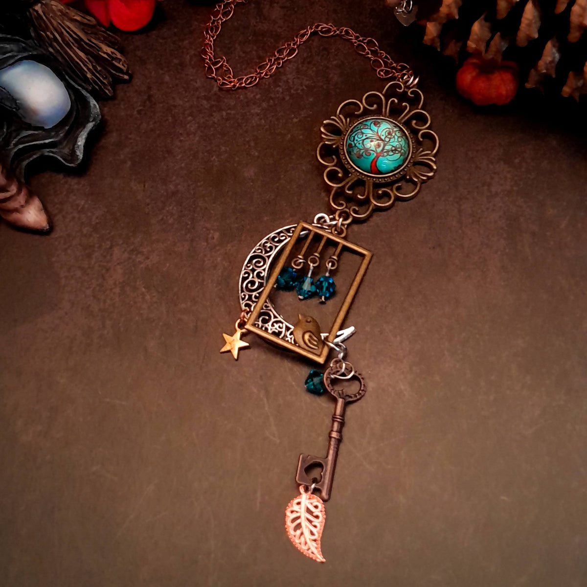 Victorian style bird necklace with tree of life cabochon, bird cage and bird, turquoise swarovski crystals silver filigree moon gold star and copper leaf. 