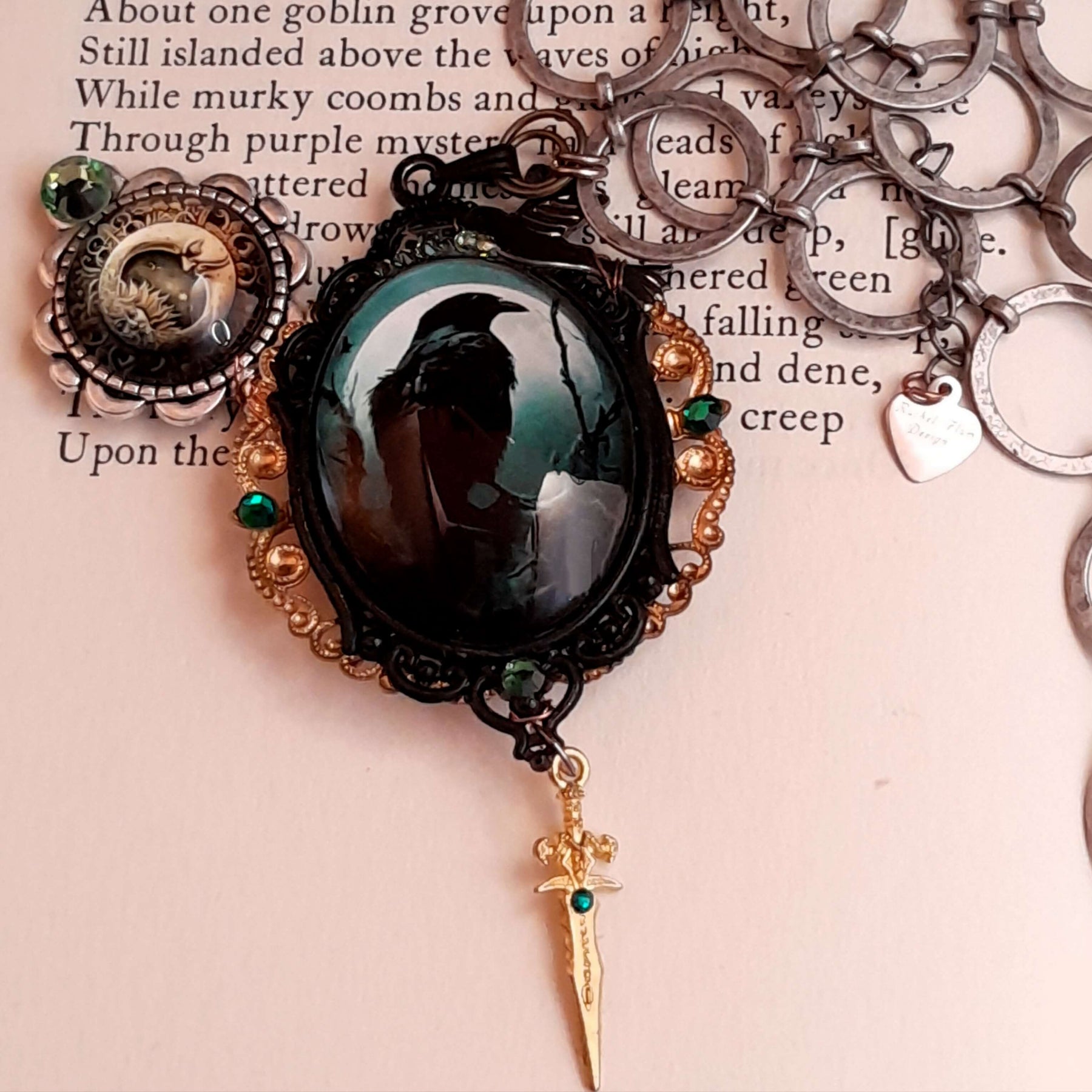 statement necklace with a black raven crow a hummingbird a dagger sun and moon bohemian cabochon on a skeleton key green swarovski crystals