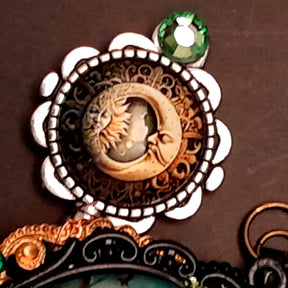 statement necklace with a black raven crow a hummingbird a dagger sun and moon bohemian cabochon on a skeleton key green swarovski crystals