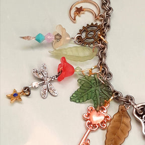 Magical fantasy butterfly necklace detail with multicolor Swarovski crystals and fairy perched on wings, handmade Victorian style vintage style bohemian jewelry