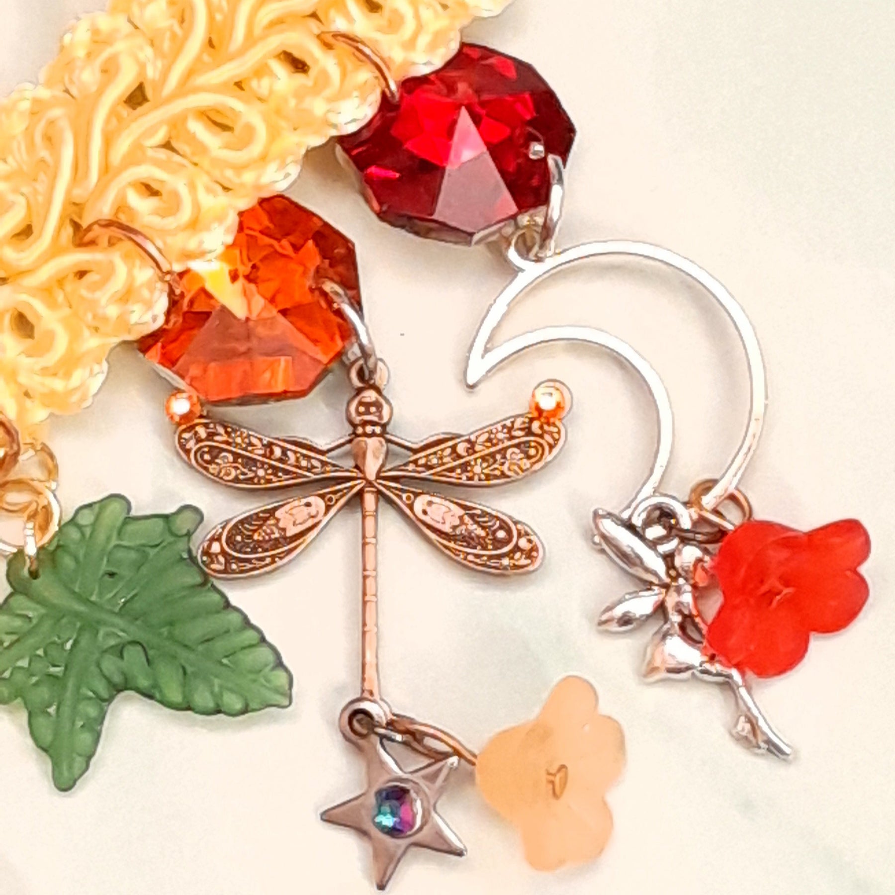 Close-up of handmade fantasy filigree dragonfly charm on yellow choker necklace Victorian style vintage style
