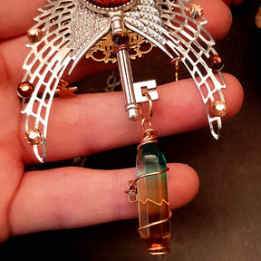bohemian necklace with sun and moon cabochon, wings, stars, color changing crystal, and swarovski crystals 