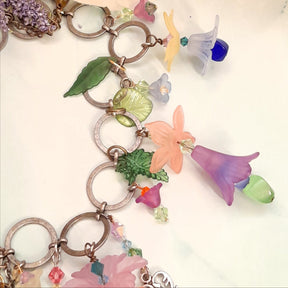 Magical fantasy boho necklace handmade with colorful Swarovski crystal flowers and nature-inspired charms, Victorian style vintage style