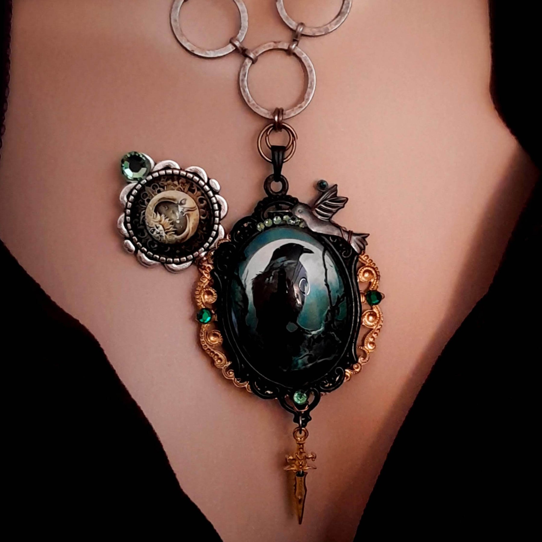 statement necklace with a black raven crow a hummingbird a dagger sun and moon bohemian cabochon on a skeleton key green swarovski crystals