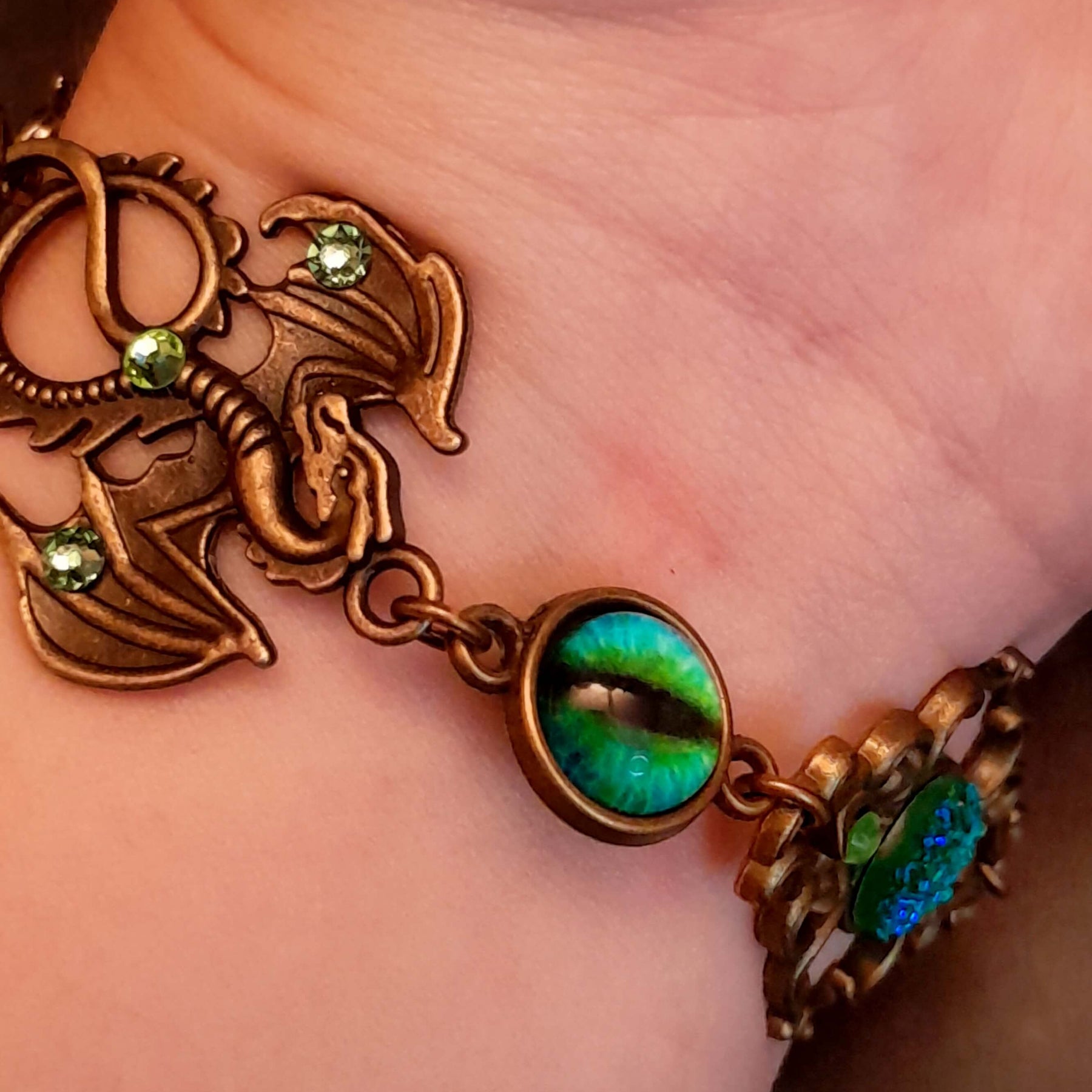 green druzy crystal bracelet with green dragon eyes and brass dragons swarovski green crystals and flower clasp