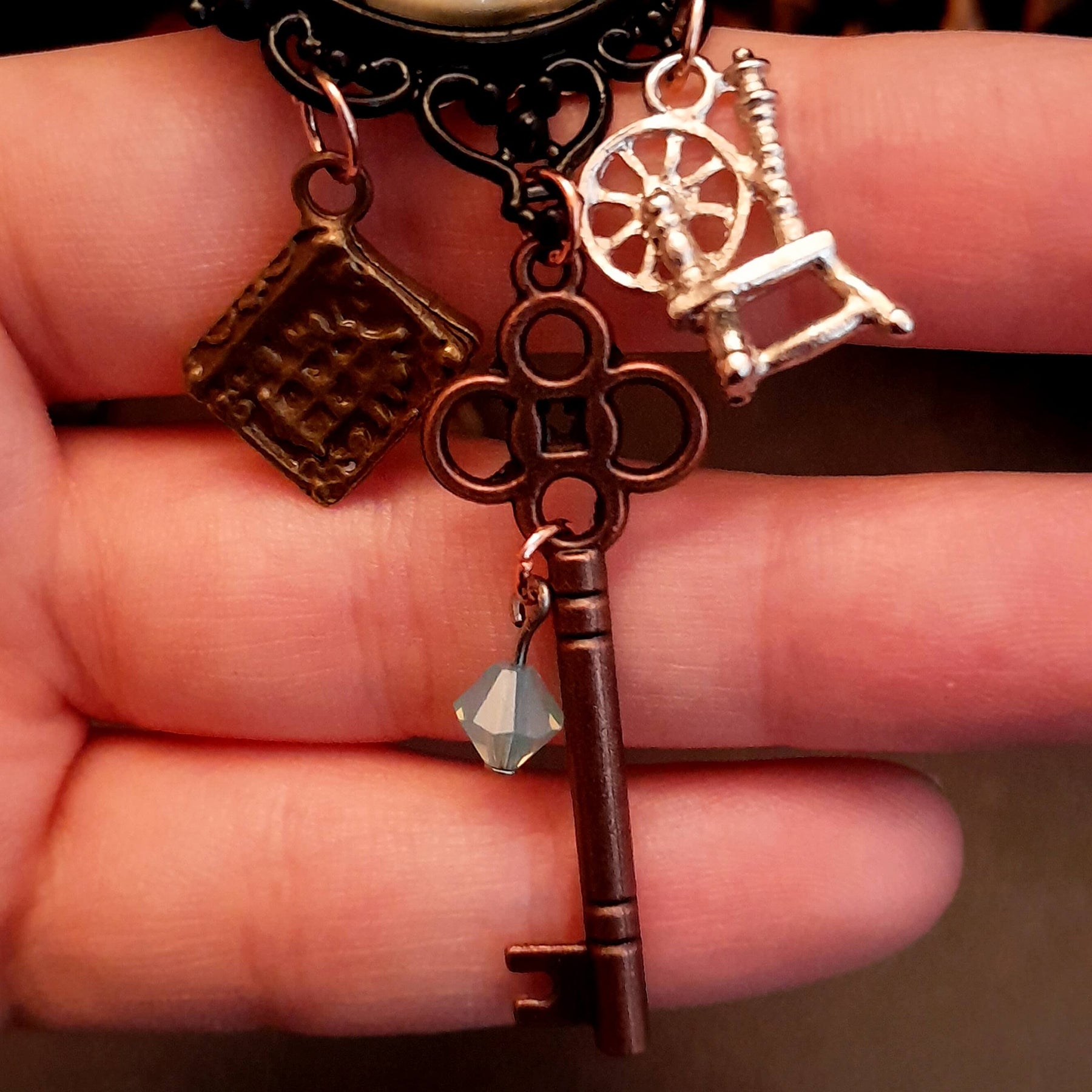 crow necklace fairytale  motifs witch hat room cauldron spinning wheel key