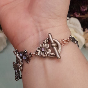 Handmade fantasy Victorian style vintage style bird bracelet with purple and blush Swarovski crystals