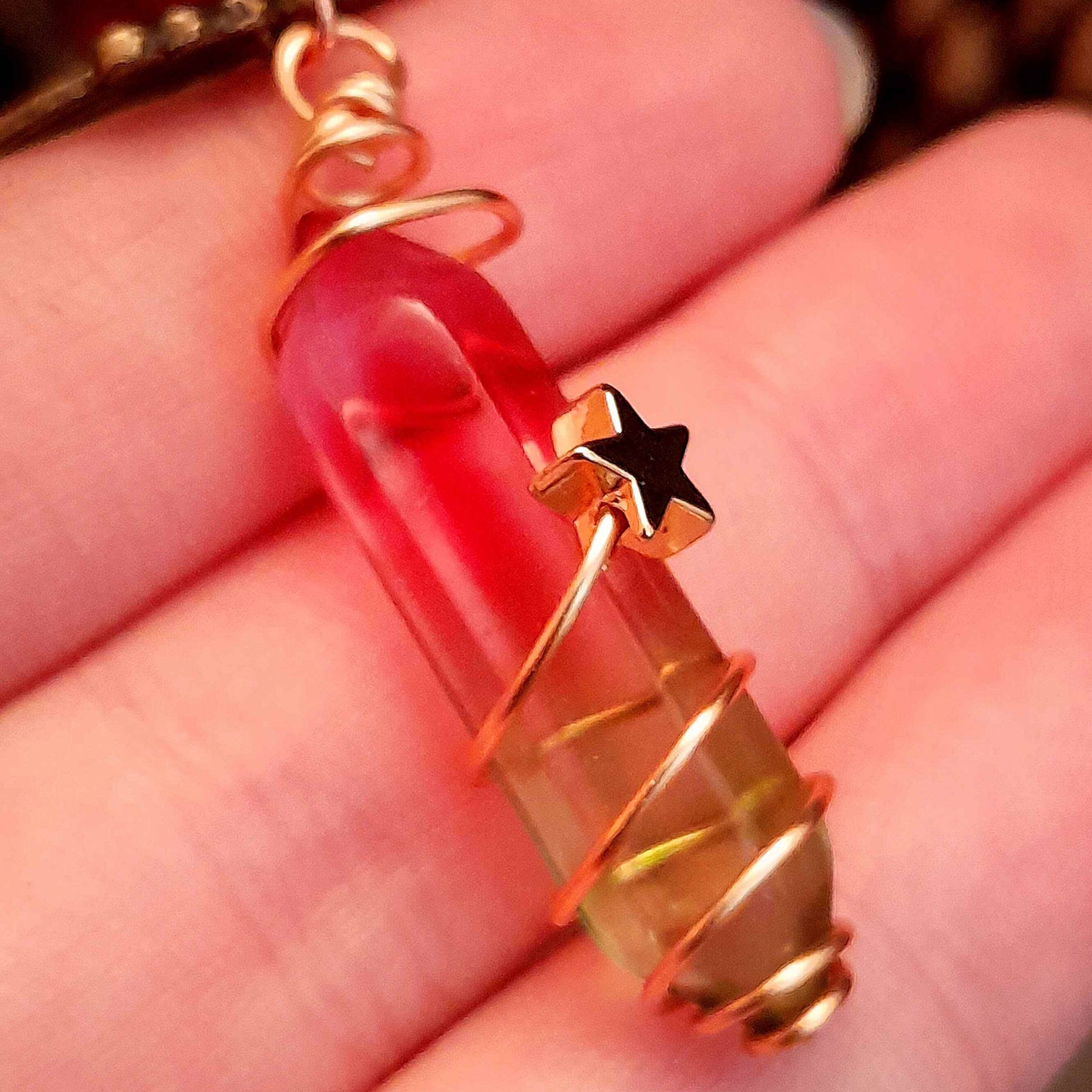 bird earrings with dangling flower and glass drops that change color from yellow to pink. wire wrapped with a moon and star