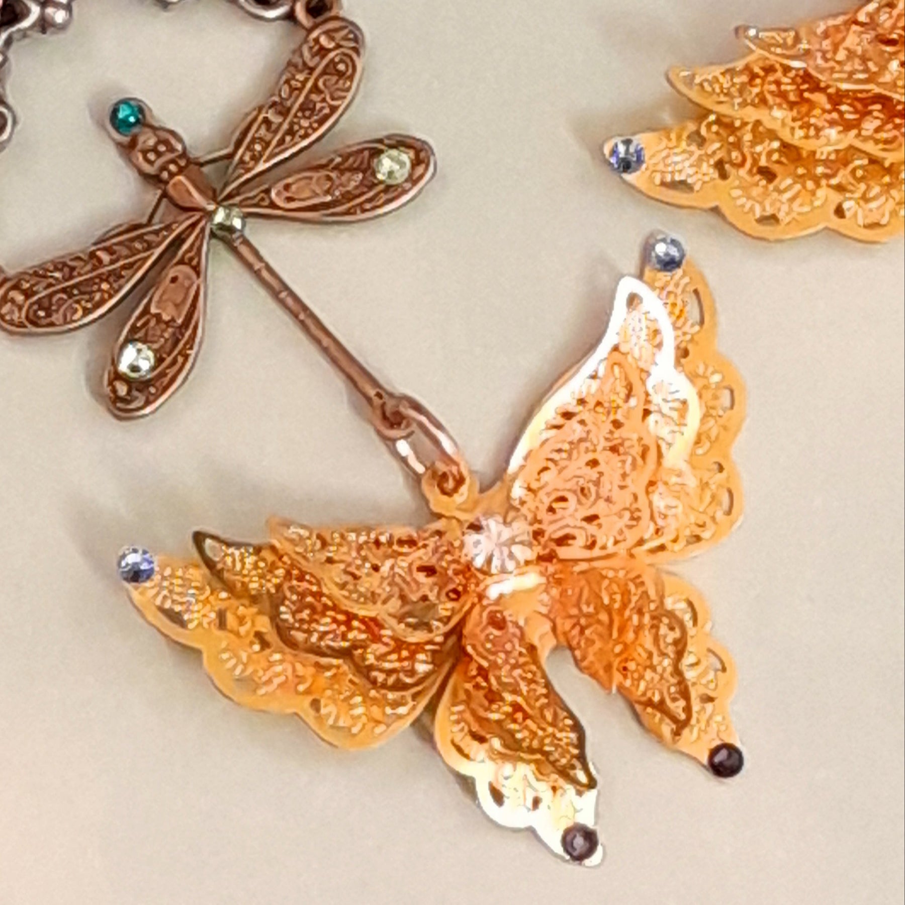 Handmade Victorian style vintage style gold tone butterfly earrings with flower charms and Swarovski crystals