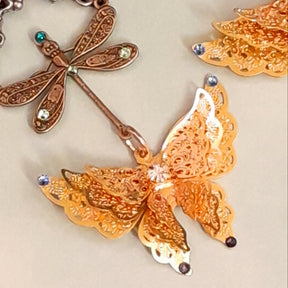 Handmade Victorian style vintage style gold tone butterfly earrings with flower charms and Swarovski crystals