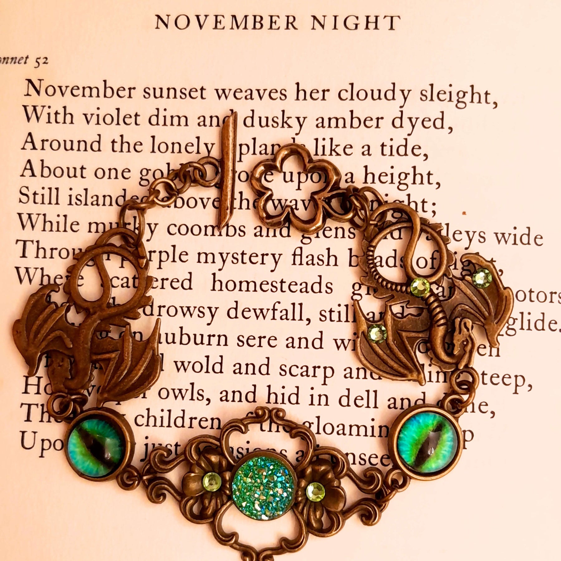 green druzy crystal bracelet with green dragon eyes and brass dragons swarovski green crystals and flower clasp