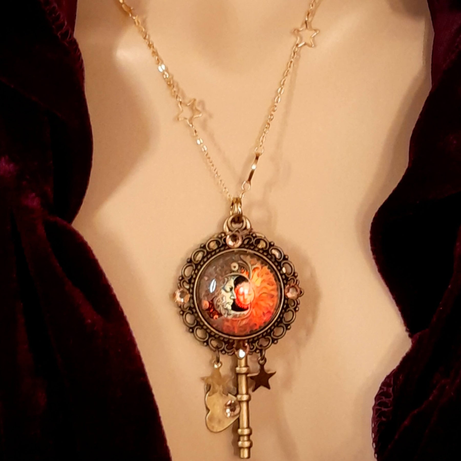 bohemian sun and moon cabochon necklace with stars and gold chain with stars and moons