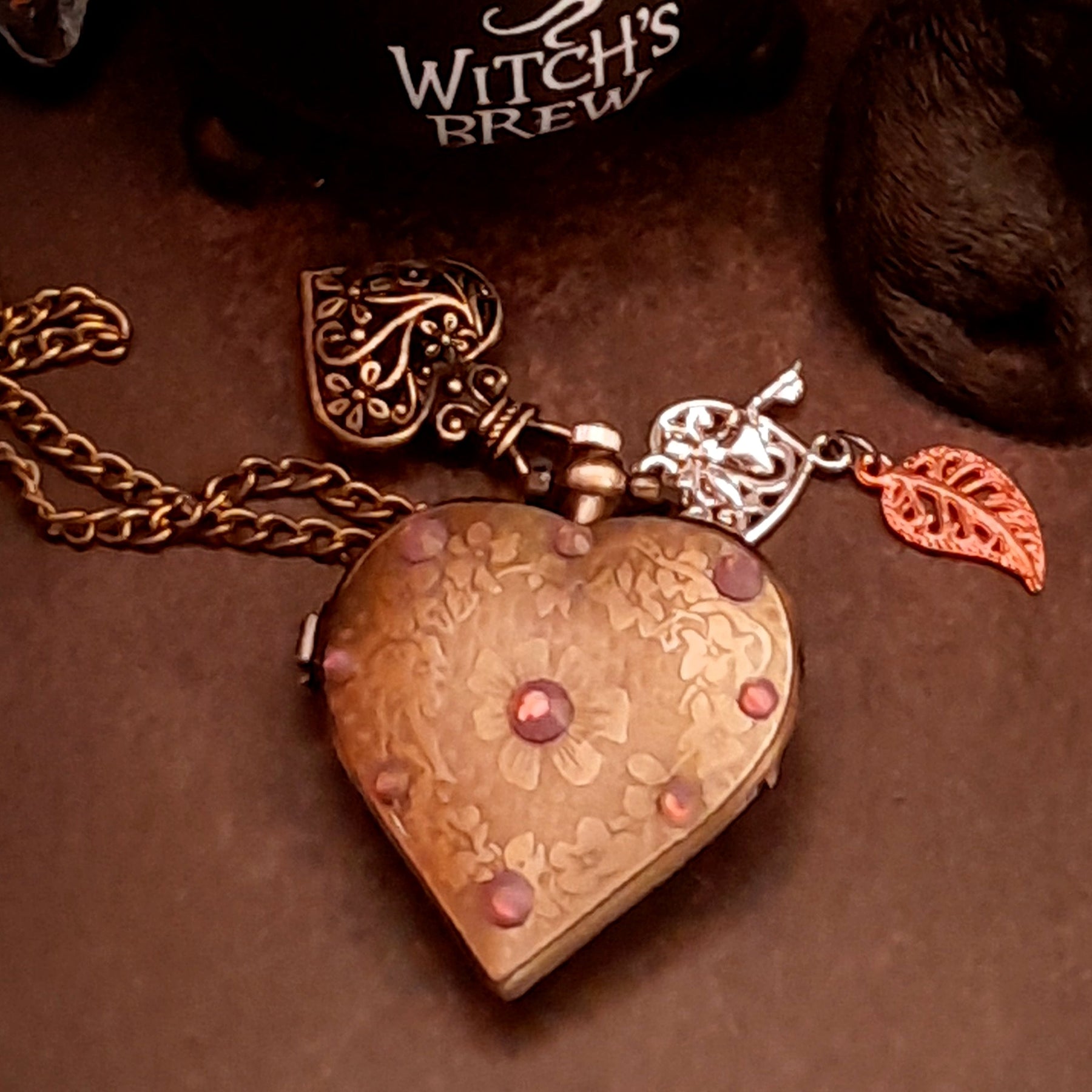 Back of handmade magical heart pocket watch necklace with engraved Victorian scrollwork and Swarovski crystal accent, vintage fantasy style