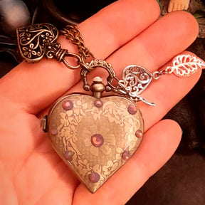 Back of handmade magical heart pocket watch necklace with engraved Victorian scrollwork and Swarovski crystal accent, vintage fantasy style