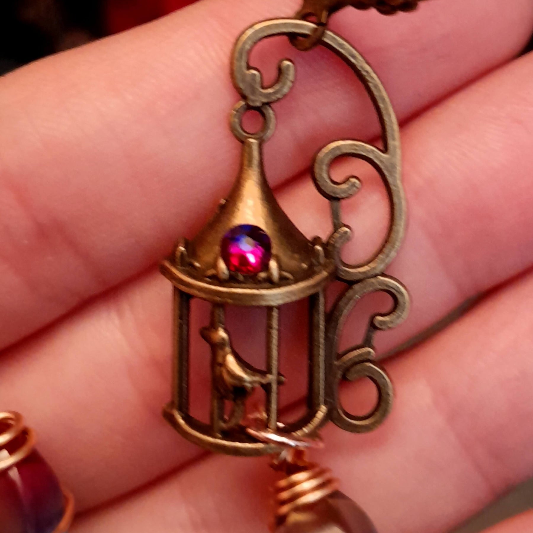 gold moon and star bird cage earrings with blue and purple color changing drop crystals 