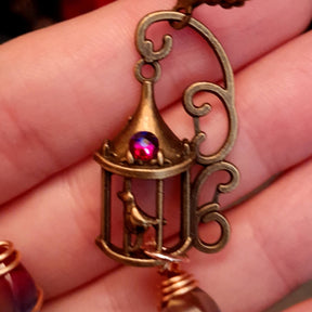gold moon and star bird cage earrings with blue and purple color changing drop crystals 