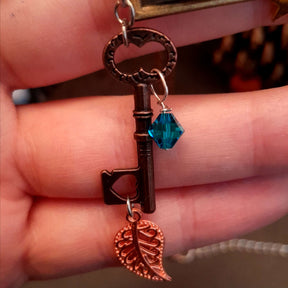 Victorian style bird necklace with tree of life cabochon, bird cage and bird, turquoise swarovski crystals silver filigree moon gold star and copper leaf. 