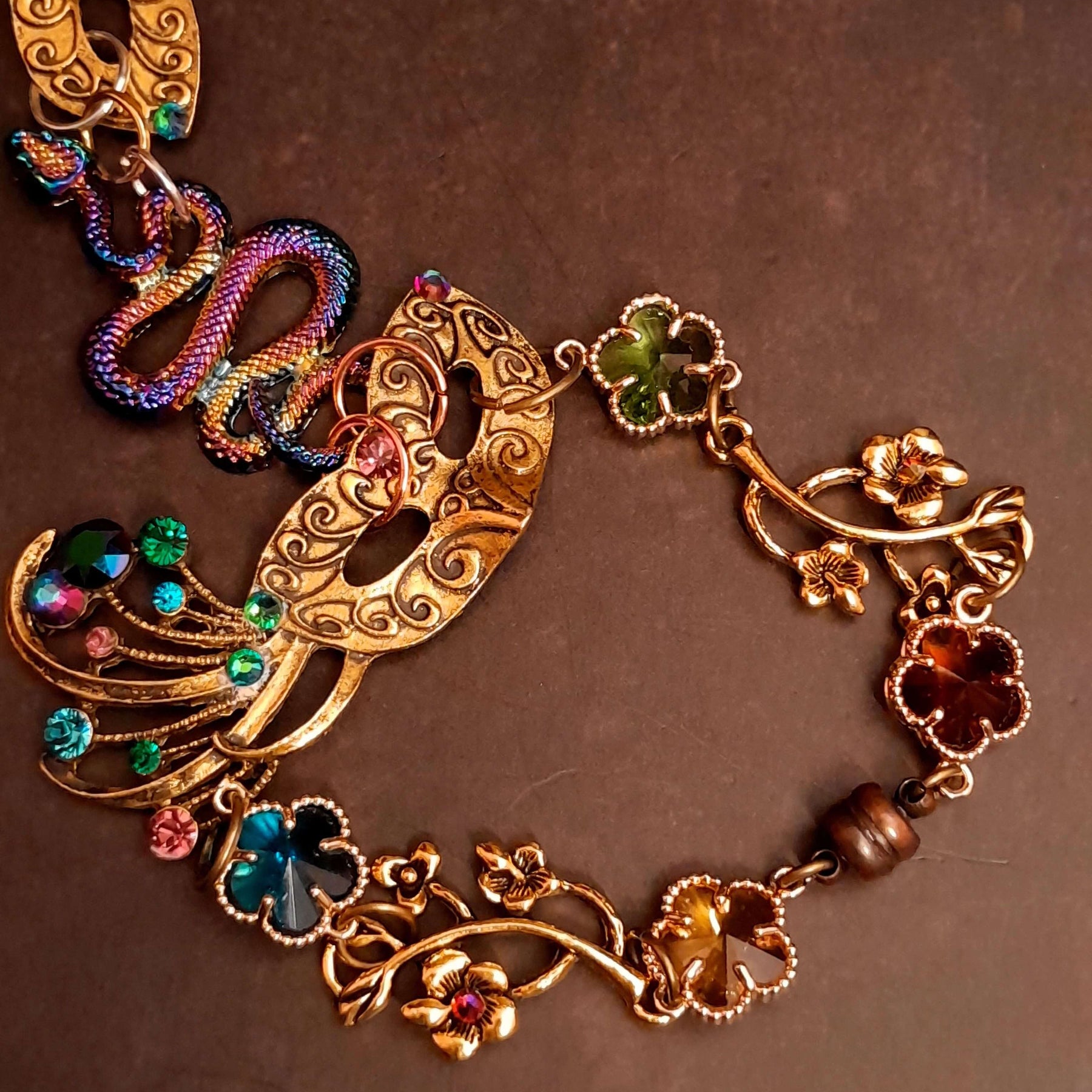 slave bracelet hand chain with adjustable flower ring and masks. colcorful flowers and vines a serpent snake and swarovski crystals