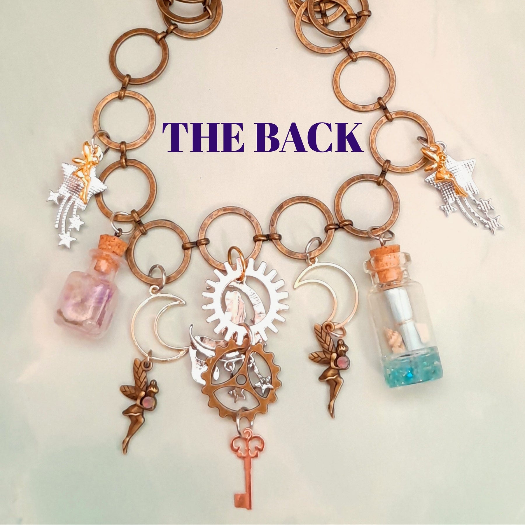 Back view of handmade magical mermaid necklace showing silver sun gear, brass gear and dangling skeleton key - Victorian style vintage style fantasy jewelry by Rachel Flam Design