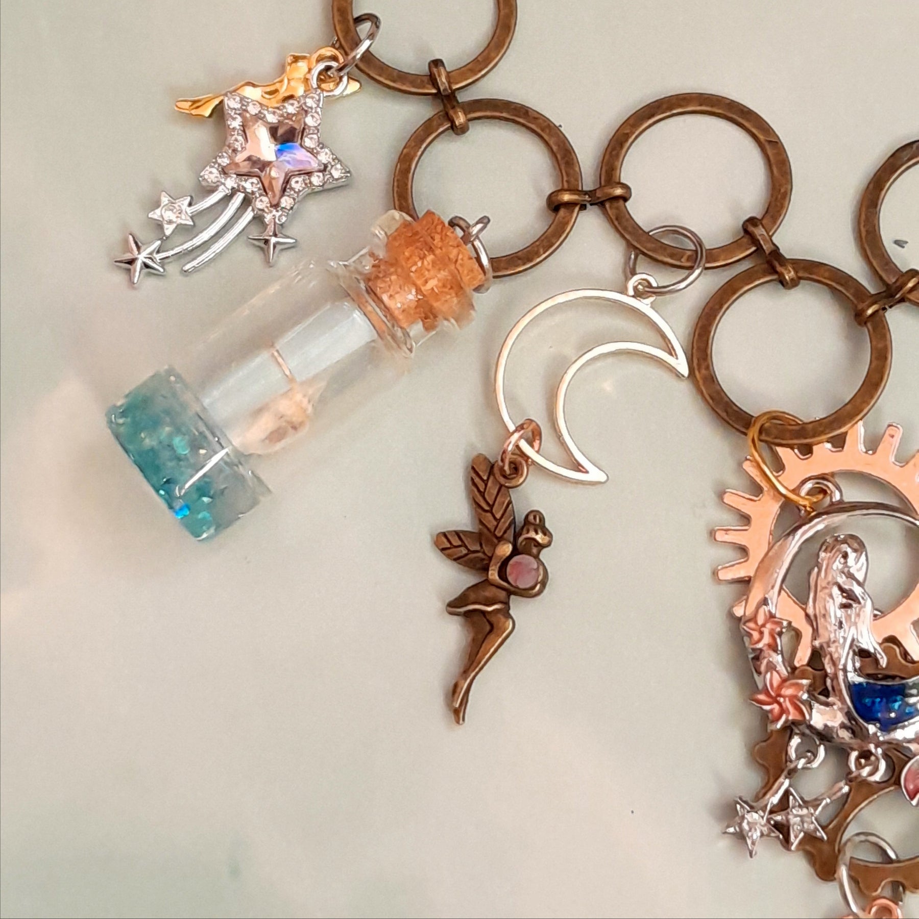 Close-up of crescent moon, Swarovski crystal shooting star and golden fairy charms on handmade magical mermaid necklace - Victorian style vintage style fantasy jewelry by Rachel Flam Design swarovski crystals
