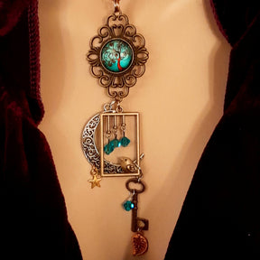 Victorian style bird necklace with tree of life cabochon, bird cage and bird, turquoise swarovski crystals silver filigree moon gold star and copper leaf. 