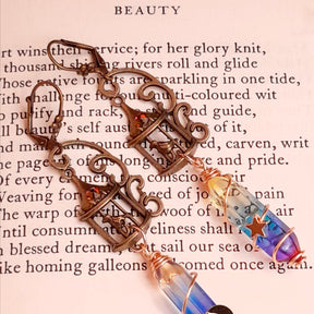 gold moon and star bird cage earrings with blue and purple color changing drop crystals 