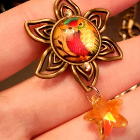 owl necklace with yellow star crystals and yellow brown tones floral settings for owl cabochons