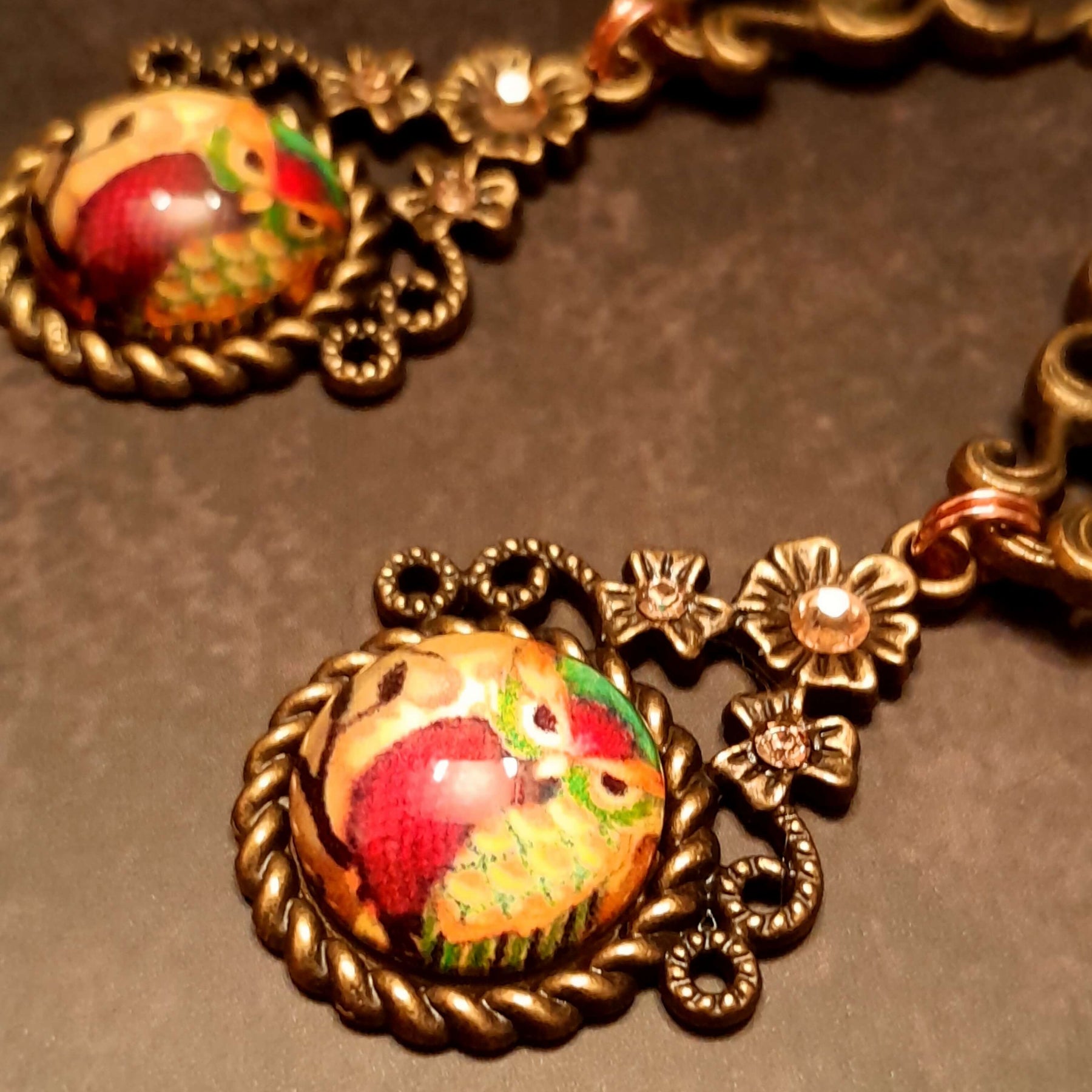 4 owl cabochons nesstled into victorian style brass settings. swarovski crystals