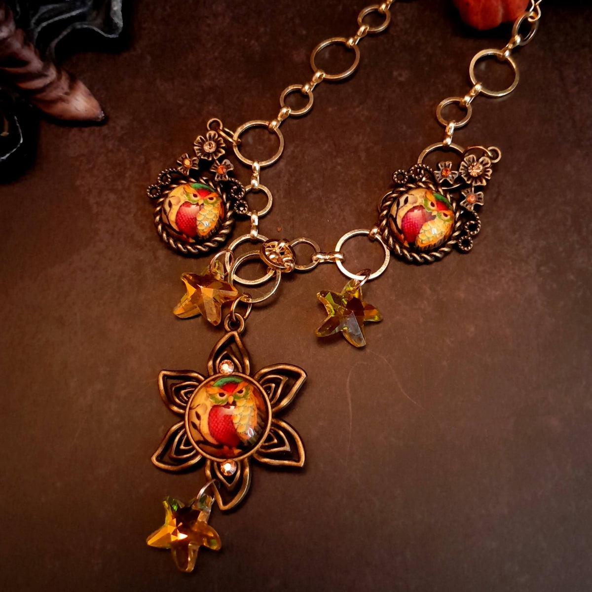 owl necklace with yellow star crystals and yellow brown tones floral settings for owl cabochons