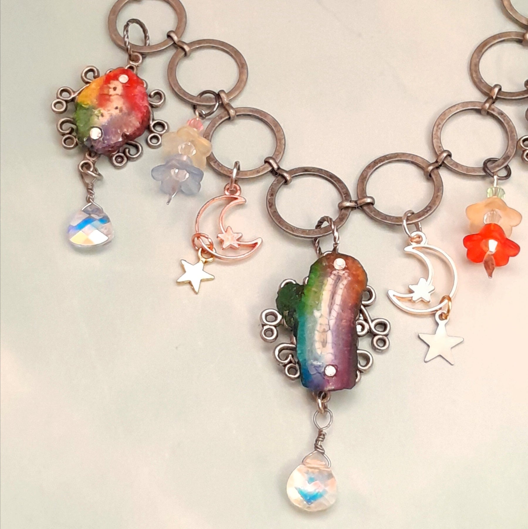 Magical fantasy rainbow stone necklace with floral and celestial pieces