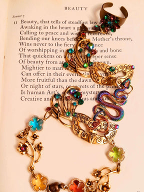 slave bracelet hand chain with adjustable flower ring and masks. colcorful flowers and vines a serpent snake and swarovski crystals