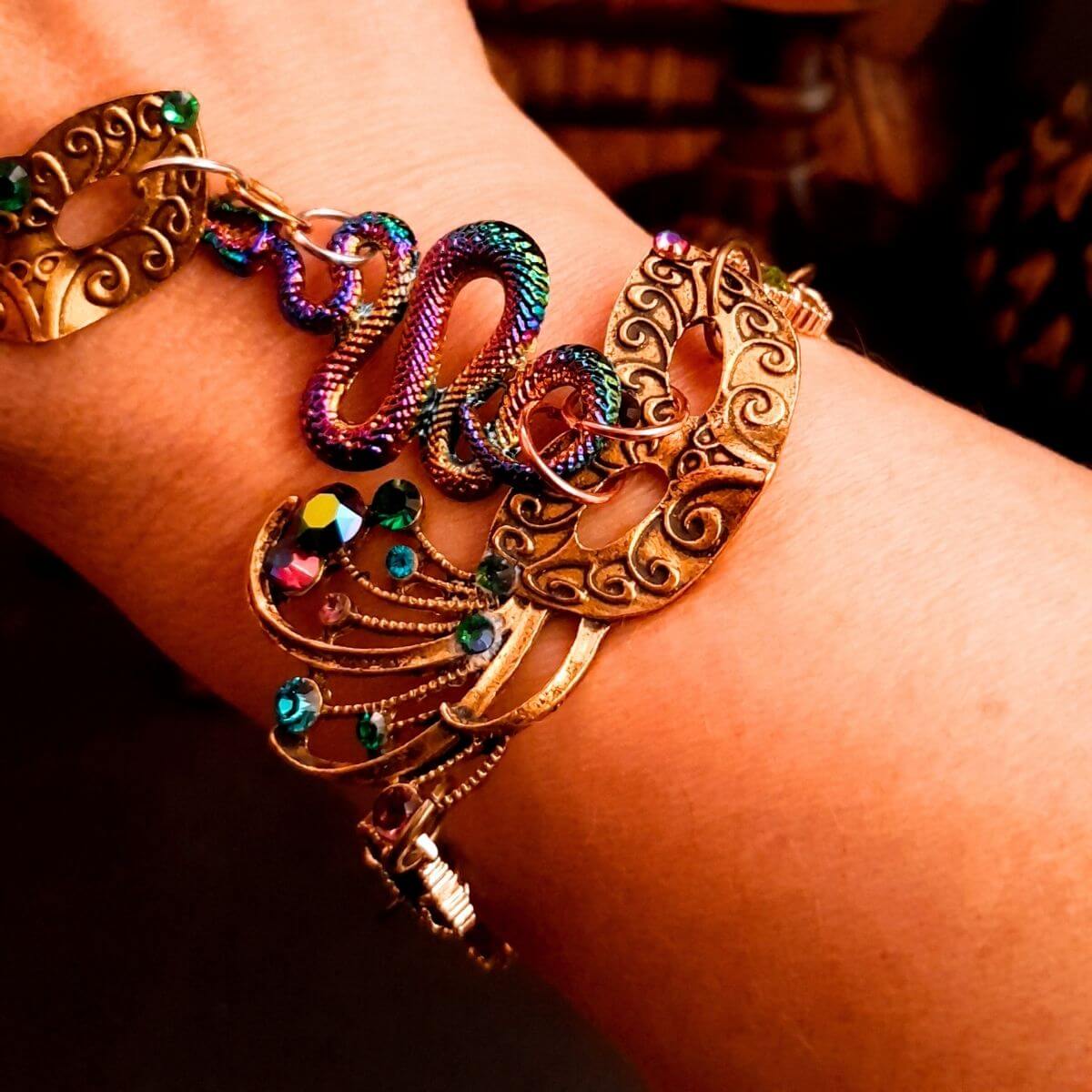 slave bracelet hand chain with adjustable flower ring and masks. colcorful flowers and vines a serpent snake and swarovski crystals