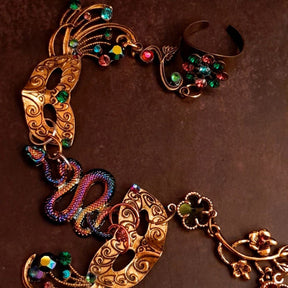 slave bracelet hand chain with adjustable flower ring and masks. colcorful flowers and vines a serpent snake and swarovski crystals