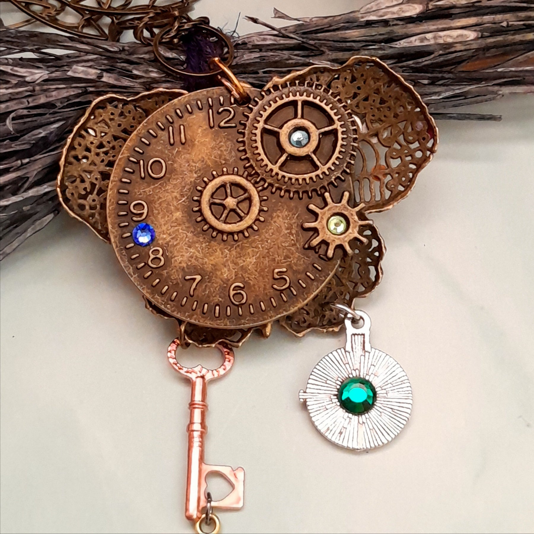 Back view of handmade magical fantasy steampunk butterfly necklace with brass clock face and gear charms, Victorian style vintage style boho jewelry