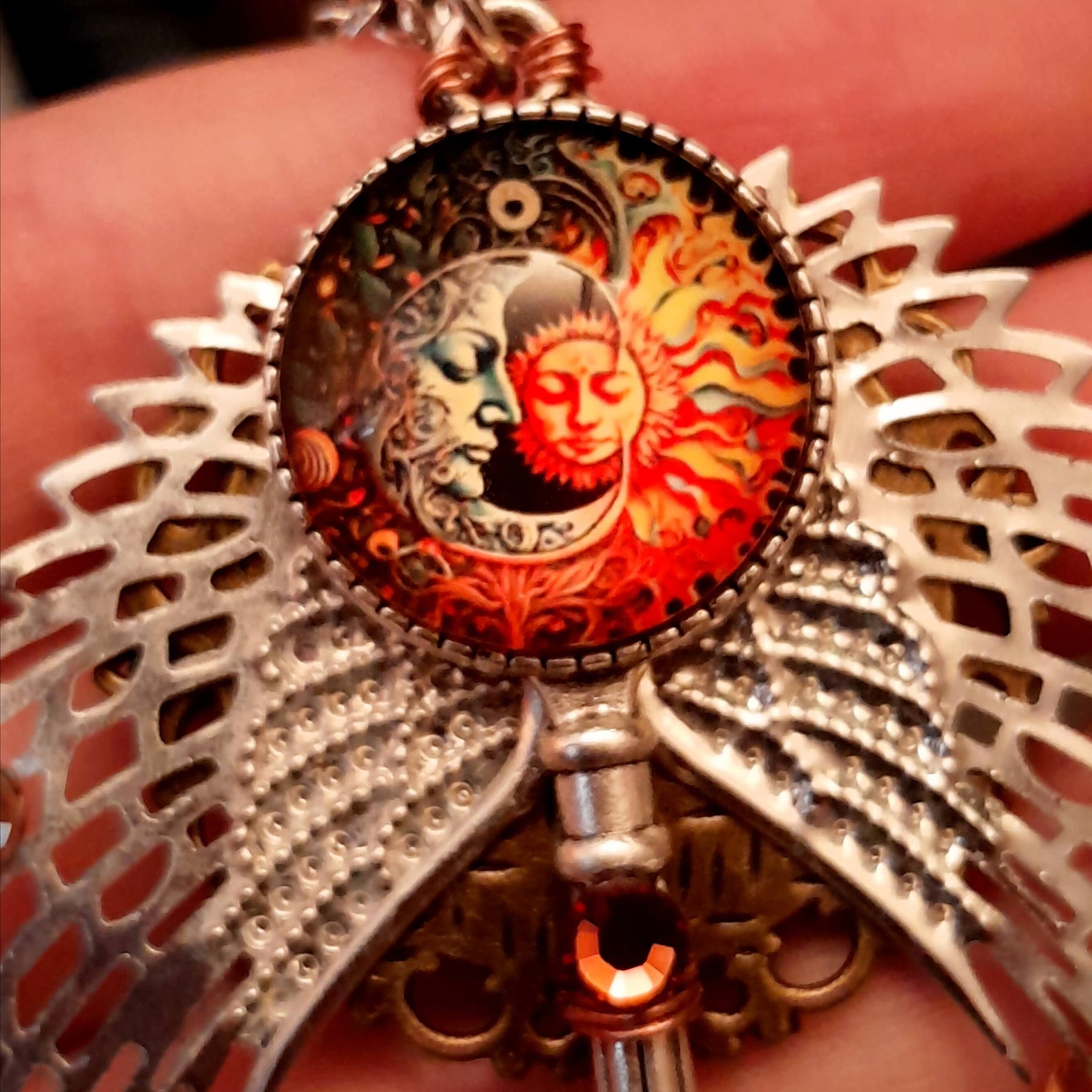 bohemian necklace with sun and moon cabochon, wings, stars, color changing crystal, and swarovski crystals 