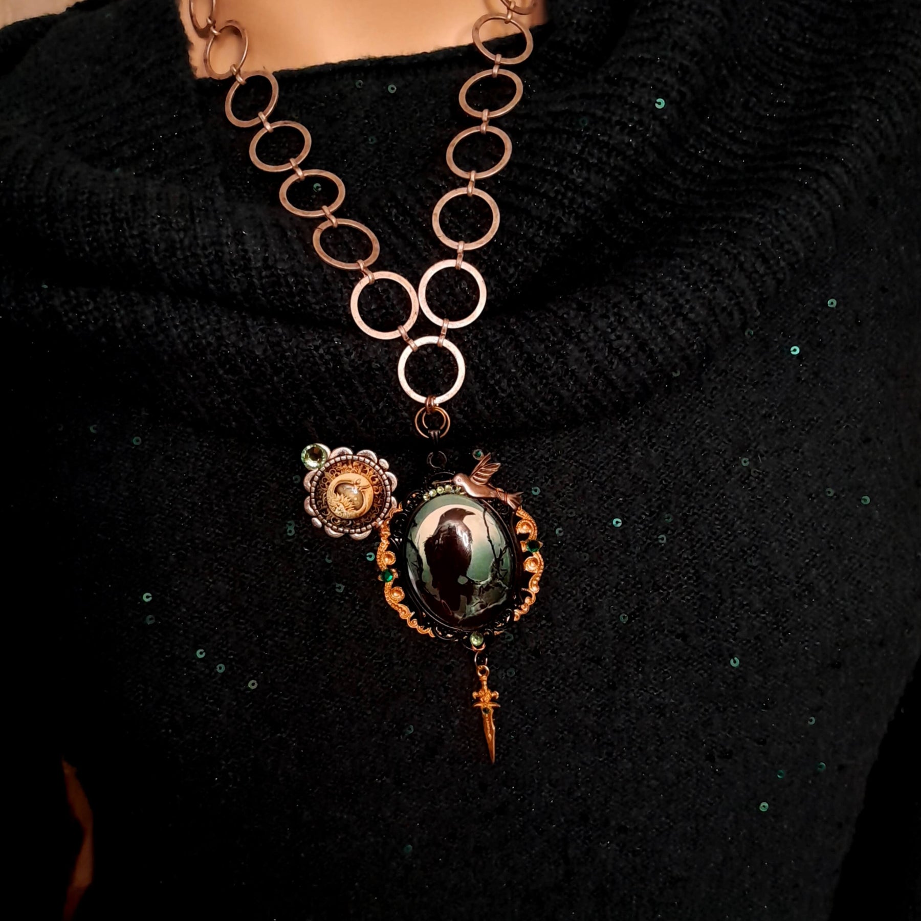 statement necklace with a black raven crow a hummingbird a dagger sun and moon bohemian cabochon on a skeleton key green swarovski crystals