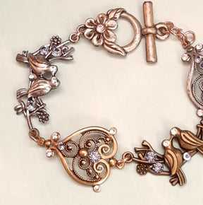 Victorian style vintage style flower toggle clasp detail on handmade birds bracelet with purple Swarovski crystals
